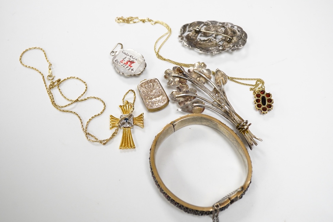 An 800 standard gilt white metal and garnet cluster set oval pendant, 18mm, on a 585 yellow metal fine link chain, 2.5 grams, a gilt white metal and garnet cluster set hinged bangle, two white metal brooches including on